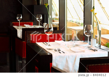beautiful serving at tables with white tablecloth and red chairs beautiful serving at tables with white tablecloth and red chairs 8404012