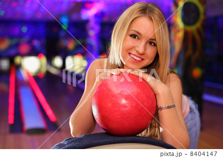 happy beautiful girl stands and bases on red ball in bowling clu happy beautiful girl stands and bases on red ball in bowling clu 8404147