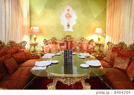 beautiful glass table with serving and red sofas in eastern luxu beautiful glass table with serving and red sofas in eastern luxu 8404204