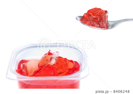 Spoon full of red gelatin. Against the background of the package Spoon full of red gelatin. Against the background of the package 8406248
