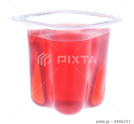 Red gelatin in a plastic yogurt cup. On a white background. 8406251