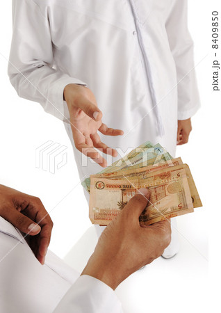 Arabic people, islamic zakat or sadaka, adult giving money to child 8409850