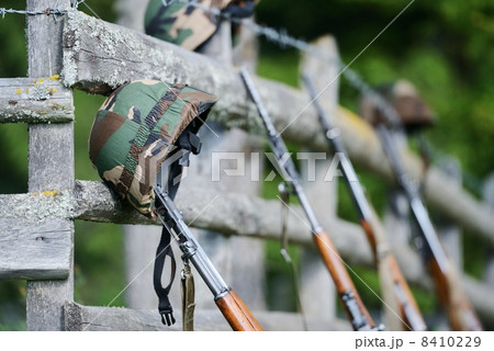 Military rifle and helmet 8410229