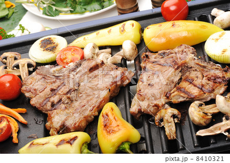 Barbecue, prepared beef meat and different vegetables and mushrooms on grill Barbecue, prepared beef meat and different vegetables and mushrooms on grill 8410321