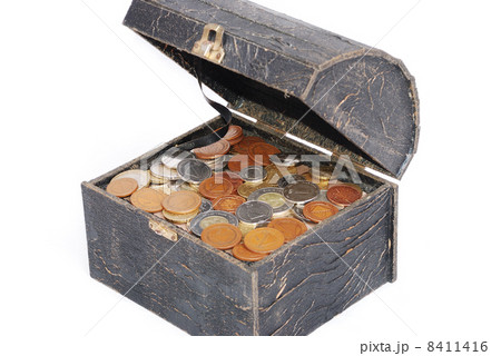 Many coins in one old chest isolated 8411416