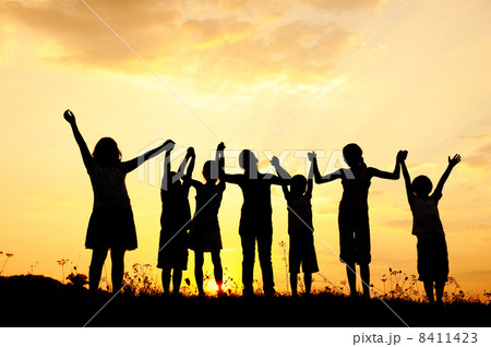 Silhouette, group of happy children playing on meadow, sunset, summertime 8411423