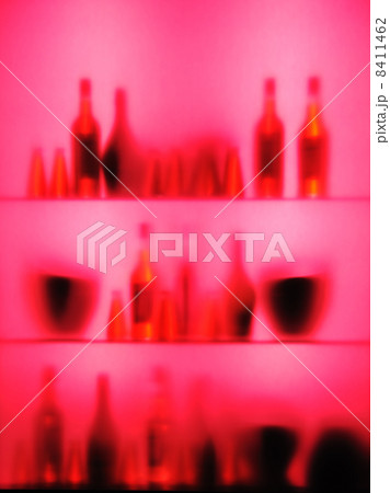 Abstract blurred vine bottles and glasses on shelf, pink color Abstract blurred vine bottles and glasses on shelf, pink color 8411462