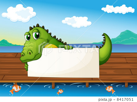 An alligator holding an empty signboard at the lake with fish 8417051