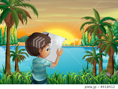 A boy with a paper at the riverbank A boy with a paper at the riverbank 8418412
