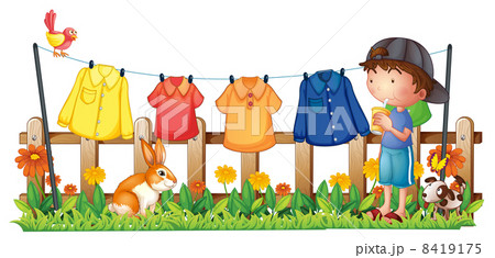 A boy drinking in the garden with hanging clothes 8419175