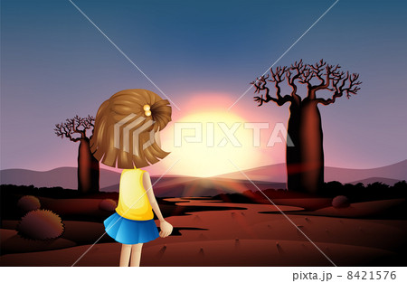 A young girl watching the sunset at the desert A young girl watching the sunset at the desert 8421576