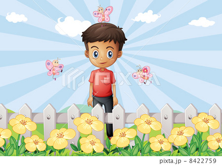 A boy in the garden with a fence 8422759