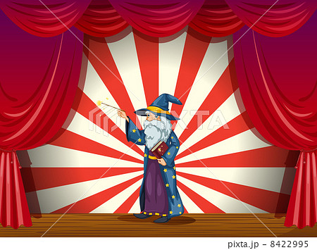 A wizard holding a wand in the middle of the stage A wizard holding a wand in the middle of the stage 8422995