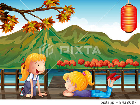 Two girls talking at the wooden bridge Two girls talking at the wooden bridge 8423087
