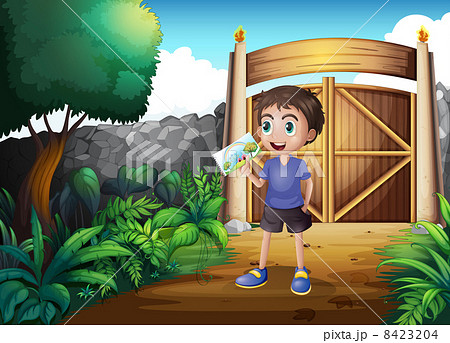 A boy holding a picture inside the gate 8423204