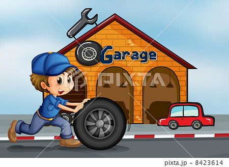 A young man pushing the tire in front of the garage 8423614