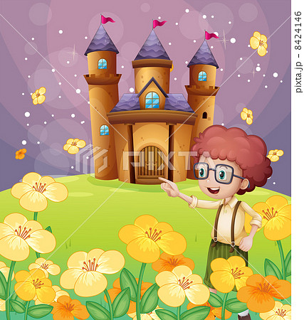 A boy pointing near the flowers in the hill with a castle A boy pointing near the flowers in the hill with a castle 8424146