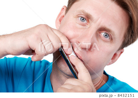 Man in blue t-shirt plays mouth harmonica 8432151