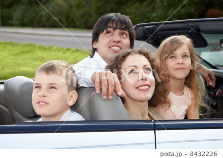 Family of four - parents and son with daughter - sits in a cabr Family of four - parents and son with daughter - sits in a cabr 8432226