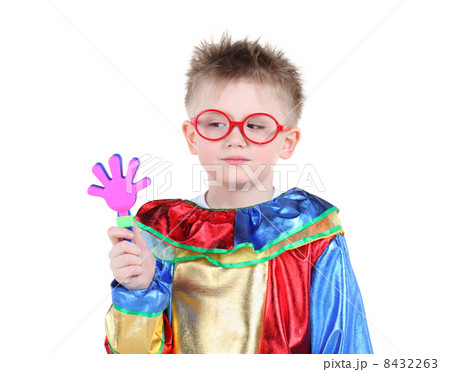 Little boy in big red glasses and clown costume holds toy hand a 8432263