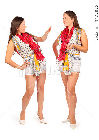 Two same women in studio on white background. First woman repres 8432825