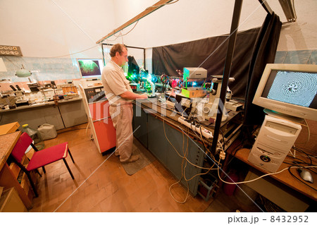 Scientist engaged in research in his lab about movement of microparticles by laser 8432952