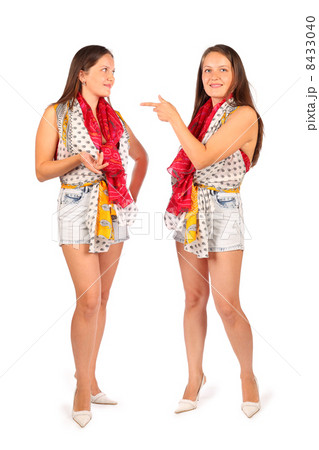 Two same women in studio on white background. First woman smiles 8433040