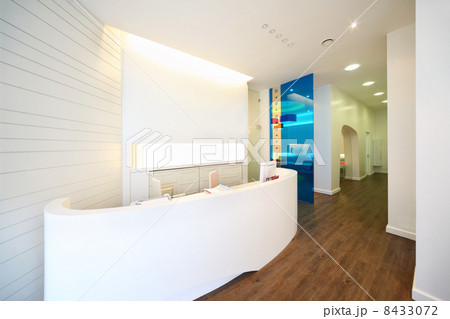 Lit reception area in dental clinic. Working place - table with 8433072