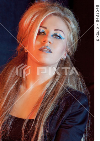 beautiful blonde girl rocker on a dark background beautiful blonde girl rocker on a dark background 8433548