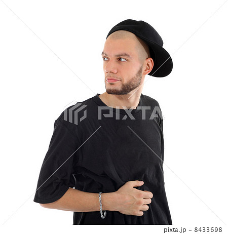 Rapper wearing black t-shirt and hat looks into distance isolate Rapper wearing black t-shirt and hat looks into distance isolate 8433698