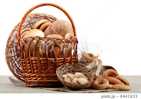 Fresh bread with ears of wheat on a wooden table. 8441833
