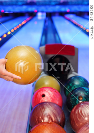 Hand of man, which takes yellow ball for throw in bowling club Hand of man, which takes yellow ball for throw in bowling club 8448236