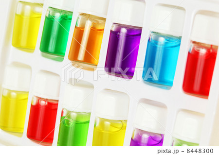 Twelve bottles of different colored aromatic oils in white plast 8448300