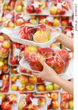 woman hands hold apples in store; woman chooses tasty and health 8448307