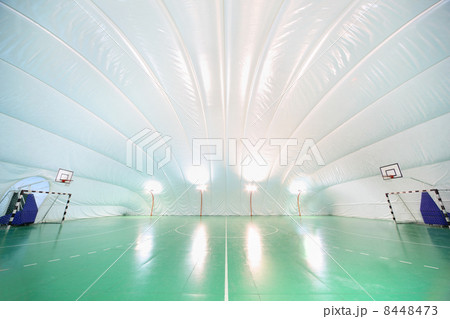 Empty indoor sports ground, plastic white ceiling and walls, gre Empty indoor sports ground, plastic white ceiling and walls, gre 8448473
