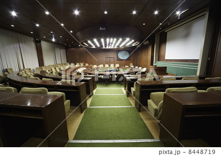 Auditorium with round oak table and beige armchairs around it. Auditorium with round oak table and beige armchairs around it. 8448719
