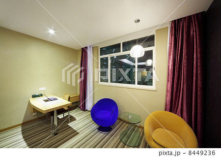 Table with notebook, two armchairs near window in stylish light 8449236