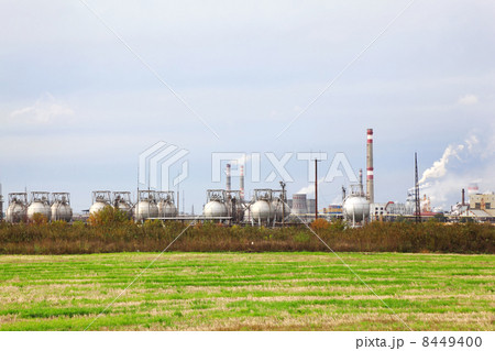 Industrial zone with factories and pipes with smoke and illumina Industrial zone with factories and pipes with smoke and illumina 8449400