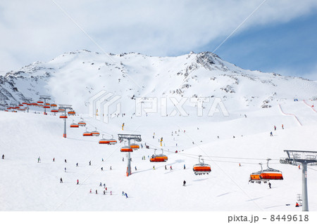 Cable car in mountains. Many skiers ride in Alps at sunny winter 8449618