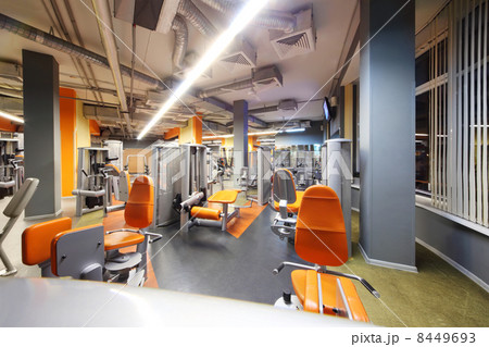 Empty gym with orange exercise equipment. Sports - part of healt Empty gym with orange exercise equipment. Sports - part of healt 8449693