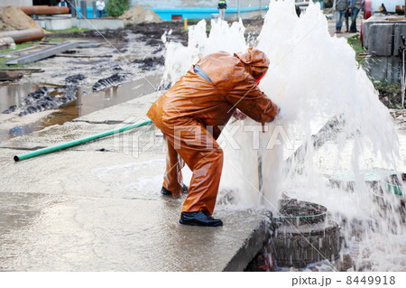 Worker in overalls eliminates breakthrough of sewerage systems. Worker in overalls eliminates breakthrough of sewerage systems. 8449918
