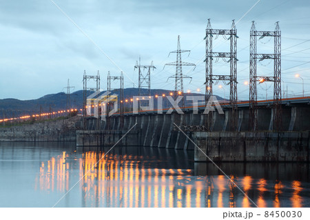 Hydroelectric power station on river at evening, posts with high Hydroelectric power station on river at evening, posts with high 8450030