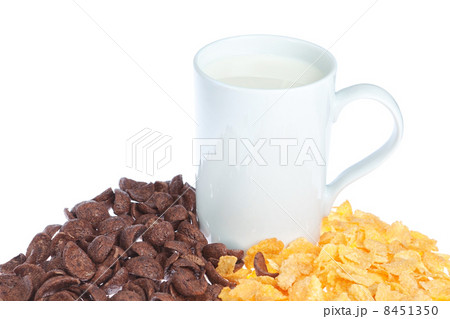 A mug of milk on cereal background on white. 8451350