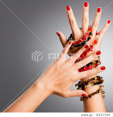 Closeup photo of a female hands with red nails 8451504