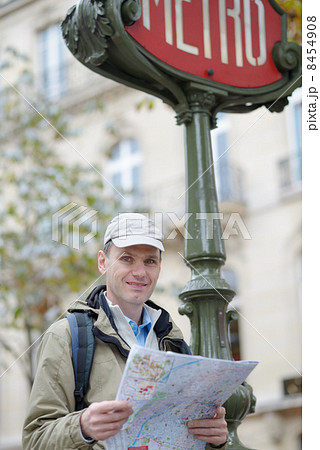 Tourist with a map in Paris, France 8454908