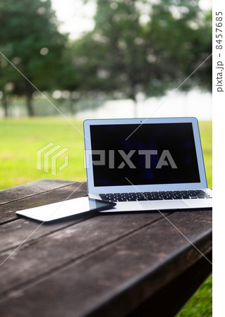Laptop & Cellphone on Park Bench 8457685