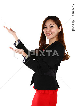 Portrait of young Asian business woman keeping finger on her lips and asking to keep quiet, on white Portrait of young Asian business woman keeping finger on her lips and asking to keep quiet, on white 8489247