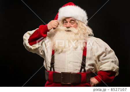 Photo of happy Santa Claus touching mustache 8527107
