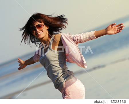 Young woman relaxing on the beach Young woman relaxing on the beach 8528586