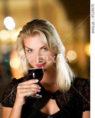 Beautiful young woman drinking red wine in a restaurant 8528670